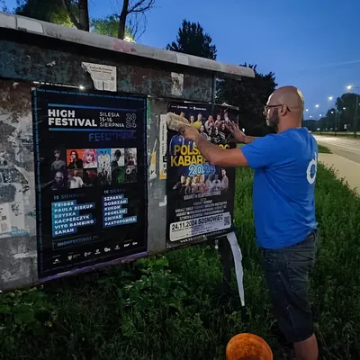 Plakaty naklejone na tablicy ogłoszeń o zmierzchu